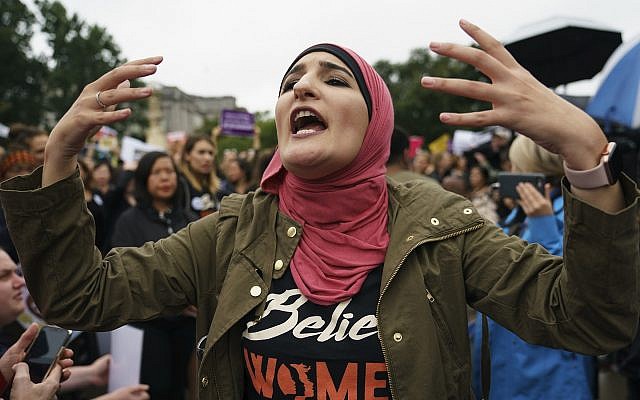 Linda Sarsour with Women's March calls out to other activists opposed to President Donald Trump's embattled Supreme Court nominee, Brett Kavanaugh, in front of the Supreme Court in Washington, on Monday, September 24, 2018.(AP Photo/Carolyn Kaster)