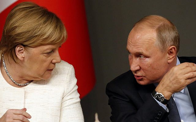 German Chancellor Angela Merkel, left, listens to Russian President Vladimir Putin as they attend a news conference following a summit on Syria, in Istanbul, October 27, 2018. (AP Photo/Lefteris Pitarakis)