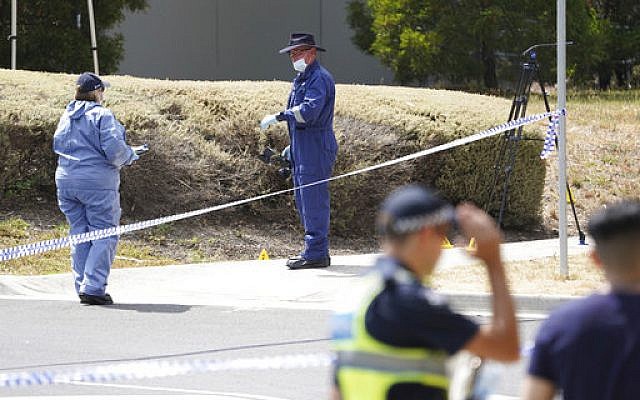 Police investigators work at the scene Wednesday, Jan. 16, 2019 where the body of Israeli student student Aiia Maasarwe was found in Melbourne, Australia. Australian police are looking for at least one attacker who killed the Israeli woman as she was walking on a city street speaking to her sister by phone. (Stefan Postles/AAP Image via AP)