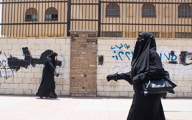 Illustrative. A female student walking past Al-Azhar university in Nasr City, Cairo, Egypt, June 9, 2015. (Mosa'ab Elshamy/AP)