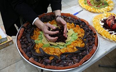 Ultra-Orthodox Jews prepare a platter for a Tu B'Shvat seder in the northern town of Meron on January 30, 2018. (David Cohen/ Flash90/ File)