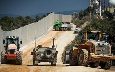 Construction work takes place near a new concrete wall on the border between Israel and Lebanon, near Rosh Hanikra in Northern Israel, on September 5, 2018. (Basel Awidat/Flash90)