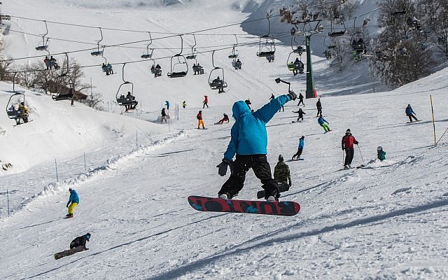 Israelis ski and snowboard on Mount Hermon on January 11, 2019. (Basel Awidat/Flash90)