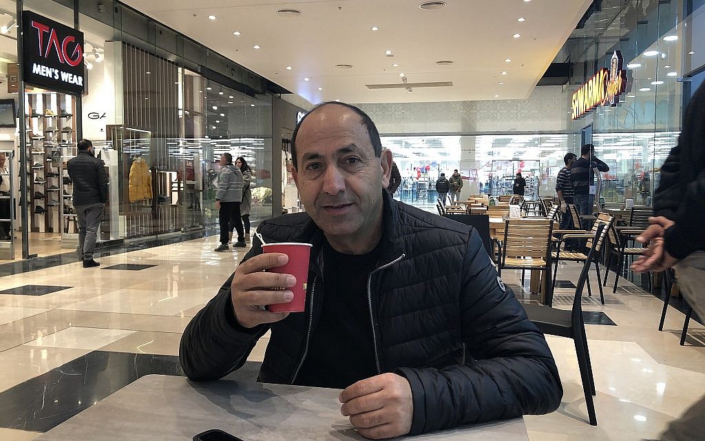 Supermarket king Rami Levy drinks coffee at Atarot Mall, his new complex on the seam of Arab and Jewish Jerusalem (Jessica Steinberg/Times of Israel)