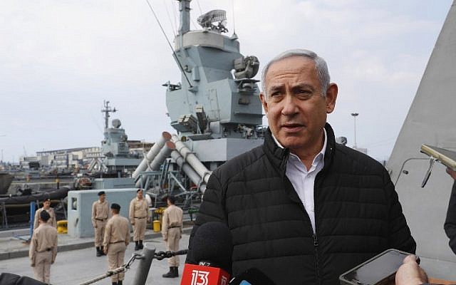 Illustrative: Prime Minister Benjamin Netanyahu speaks to journalists during a visit to inspect a naval Iron Dome defense system in the northern port of Haifa on February 12, 2019. (Jack Guez/Pool/AFP)