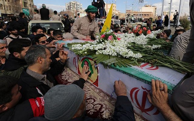 Illustrative: Iranian mourners gather around the coffins of Revolutionary Guards members who were killed in a suicide attack, during their funeral in southeastern city of Isfahan on February 16, 2019. (Atta Kenare/AFP)