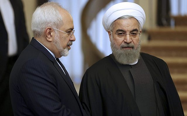 In this photo from November 24, 2015, Iranian President Hassan Rouhani, right, listens to his Foreign Minister Mohammad Javad Zarif prior to a meeting in Tehran, Iran. (AP Photo/Vahid Salemi, File)