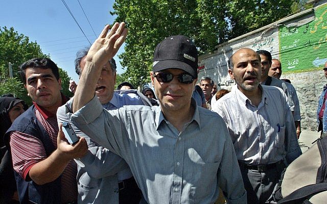 One of Iran's most prominent dissident journalist's, Akbar Ganji,  who was jailed in 2000 after his probe of the murders of five dissidents by Intelligence Ministry agents, waves, as he enters the Evin prison after a temporary release for medical reasons, in Tehran, Iran, June 11, 2005.  (AP/Vahid Salemi/File)