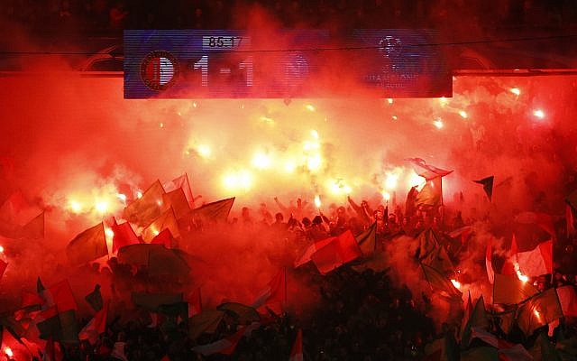 Illustrative: Feyenoord's fans light up flares during a Champions League Group F soccer match between Feyenoord and Napoli at the Kuip stadium in Rotterdam, Netherlands, on December 6, 2017. (AP Photo/Peter Dejong)