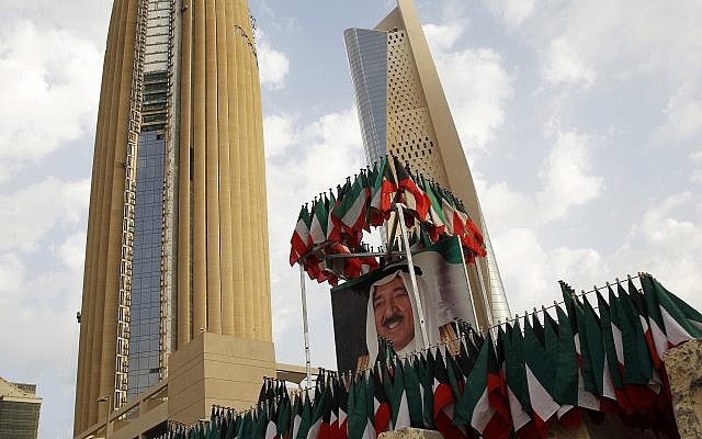 Illustrative: A picture of Kuwait's ruling emir, Sheikh Sabah Al Ahmad Al Sabah, is displayed with surrounding Kuwaiti flags in Kuwait City, on February 14, 2018. (AP Photo/Jon Gambrell/File)