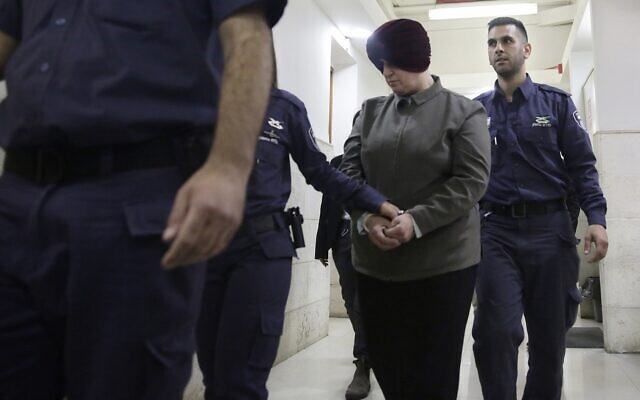 In this February 27, 2018, photo, Malka Leifer, center, is brought to a courtroom in Jerusalem. (AP Photo/Mahmoud Illean)