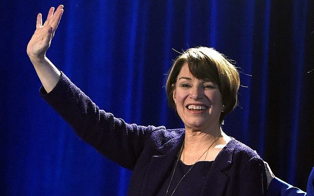 In this November 6, 2018, file photo, Sen. Amy Klobuchar waves to supporters after winning re-election during the Democratic election night party in St. Paul, Minnsota (AP Photo/Hannah Foslien
