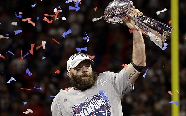 New England Patriots' Julian Edelman (11) holds the Vince Lombardi Trophy after the NFL Super Bowl 53 football game against the Los Angeles Rams, Sunday, Feb. 3, 2019, in Atlanta. The Patriots won 13-3. Edelman was named the Most Valuable Player. (AP Photo/Mark Humphrey)