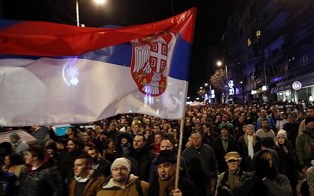 In this file photo dated Feb. 2, 2019, people march during a protest against populist President Aleksandar Vucic in Belgrade, Serbia (AP Photo/Darko Vojinovic, FILE)