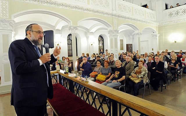 Chief Rabbi of Poland Michael Schudrich, left, who co-wrote the letter of complaint against Israel Katz, seen speaking to visitors in a synagogue in Warsaw in 2015. (AP Photo/Alik Keplicz/File)