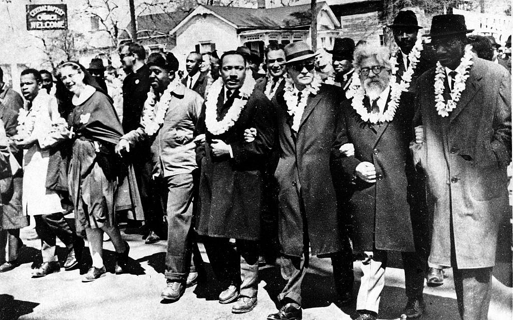 Dr. Martin Luther King Jr. links arms with other civil rights leaders as they begin the march to the state capitol in Montgomery from Selma, Alabama, on March 21, 1965. The demonstrators are marching for voter registration rights for blacks. Accompanying Dr. Martin Luther King Jr. (fourth from right), are on his left Ralph Bunche, undersecretary of the United Nations, Rabbi Abraham Joshua Heschel, and Rev. Fred Shuttlesworth. (AP Photo)