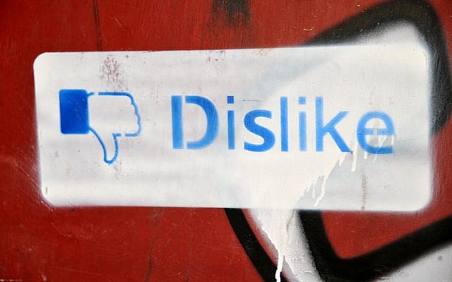 Graffiti on a wall in Jerusalem of a 'dislike' thurmbs-down sign, based on Facebook's thumbs-up 'like' sign. May 26,2011. (Sophie Gordon / Flash 90)