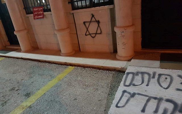 Graffiti on mosque in Palestinian West Bank village of Deir Dibwan in suspected hate crime, February 4, 2019 (Deir Dibwan local council)