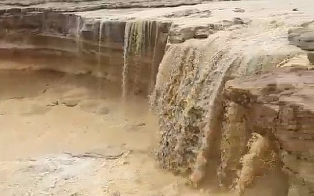 Screen capture from video of rainwater flooding into the Ramon Crater in the southern Negev region, February 7, 2019. (Twitter)
