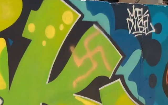 A swastika spray-painted on a mural at Bondi Beach in Sydney, Australia, February 10, 2019. (Screenshot: Twitter)