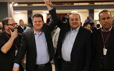 MKs Ayman Odeh and Ahmad Tibi react after submitting a joint list of candidates from their Hadash and Ta'al parties to the Central Elections Committee at the Knesset on February 21, 2019. (Hadash)