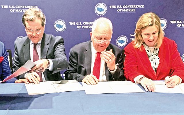 Signing the agreement on Jan. 24 between the American Jewish Committee and the US Conference of Mayors for AJC to host annual trips to Israel for US mayors (L to R): AJC CEO David Harris, Conference of Mayors CEO Tom Cochran, and Conference of Mayors International Committee Chair Nan Whaley, Mayor of Dayton. (US Conference of Mayors/ via Dayton Jewish Observer)