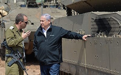 Illustrative: Prime Minister Benjamin Netanyahu, right, speaks with an IDF officer near the border with the Gaza Strip on March 28, 2019. (Kobi Gideon/GPO)
