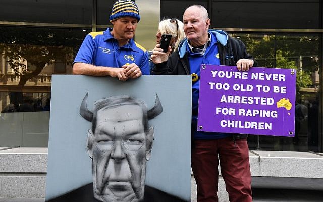 Protesters hold placards outside the County Court to hear the sentencing of Cardinal George Pell in Melbourne on March 13, 2019. - Disgraced Australian Cardinal George Pell was sentenced to six years in jail for child sex crimes in a Melbourne court on March 13 with a minimum period of three years and eight months to be served. (William WEST / AFP)