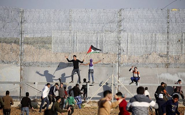Palestinians riot on the border fence with Israel east of Gaza City on March 22, 2019. (Said Khatib/AFP)