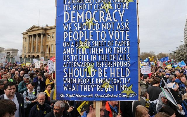 People hold up placards and European flags as they attend a march and rally organised by the pro-European People's Vote campaign for a second EU referendum in central London on March 23, 2019. (Isabel INFANTES / AFP)