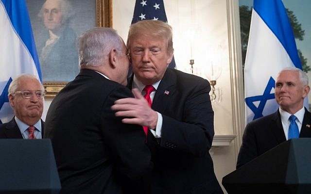 US President Donald Trump (R) and Prime Minister Benjamin Netanyahu embrace prior to signing a Proclamation on the Golan Heights in the Diplomatic Reception Room at the White House, March 25, 2019. (Saul Loeb/AFP)