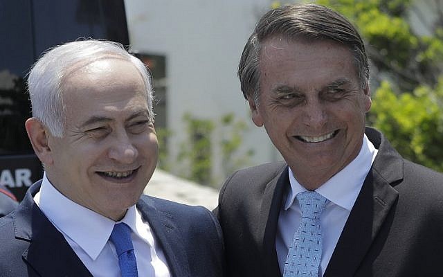 In this photo from December 28, 2018, Prime Minister Benjamin Netanyahu (L) is welcomed by Brazil's then president-elect Jair Bolsonaro at the Copacabana fort in Rio de Janeiro, Brazil. (Leo Correa/Pool/AFP)