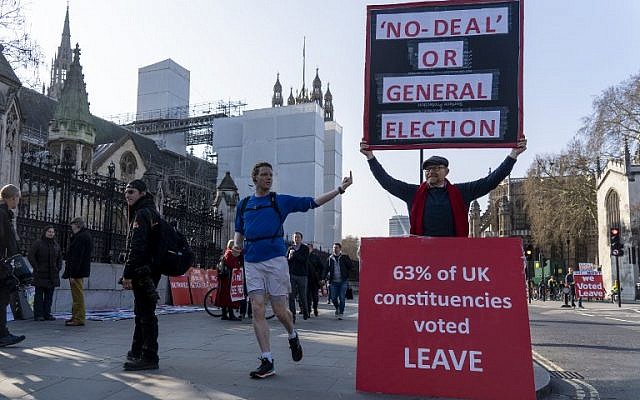 A jogger gives the middle finger to a pro-Brexit demonstrator outside the Houses of Parliament in London on March 29, 2019. (Niklas Halle’n/AFP)