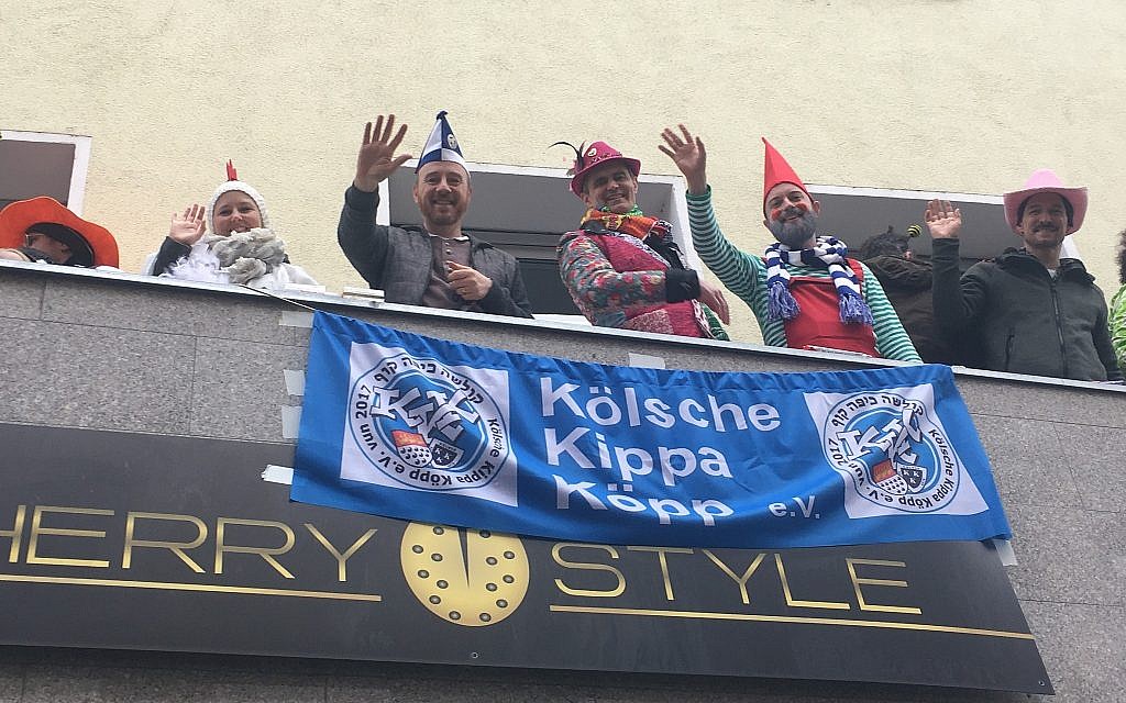 Aaron Knappstein, in blue and white tam, watching the Cologne carnival with friends. (Toby Axelrod/ JTA)