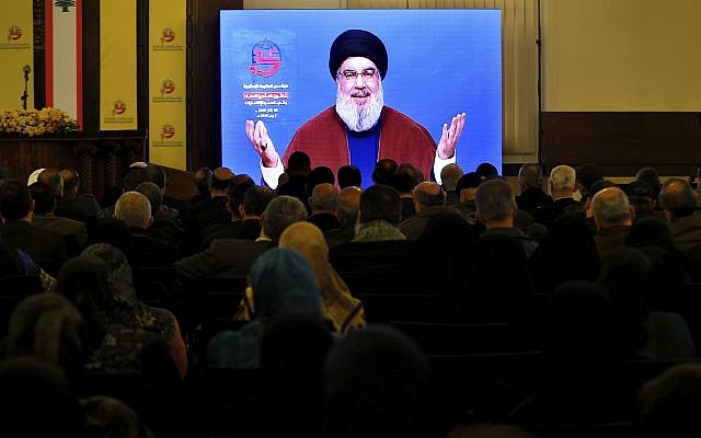 Supporters of the Iranian-backed Hezbollah terror group listen to a speech by Hezbollah leader Hassan Nasrallah via a video link in a southern suburb of Beirut, Lebanon, March 8, 2019. (AP Photo/Bilal Hussein)