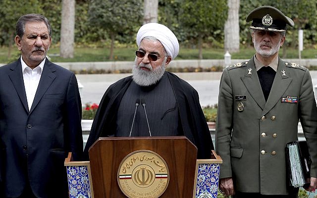President Hassan Rouhani, center, speaks during a media briefing after a cabinet meeting, as senior Vice President Eshaq Jahangiri, left, and Defense Minister Gen. Amir Hatami listen, in Tehran, Iran, March 18, 2019. (Iranian Presidency Office via AP)