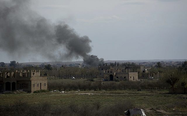 Smoke rises from a strike on Baghouz, Syria, on the Islamic State group's last piece of territory on March 22, 2019. (AP Photo/Maya Alleruzzo)