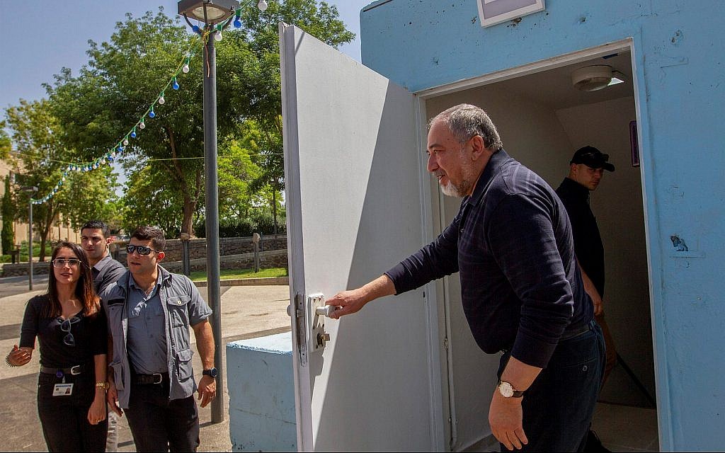 Then-Israeli Defense Minister Avigdor Liberman seen at the entrance to a bomb shelter during his visit in Katzrin, May 11, 2018. (Basel Awidat/Flash90)