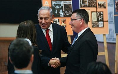 Prime Minister Benjamin Netanyahu shakes hands with Likud candidate Gideon Sa’ar as he arrives for a Likud faction meeting at the Menachem Begin Heritage Center in Jerusalem on March 11, 2019. (Yonatan Sindel/Flash90)