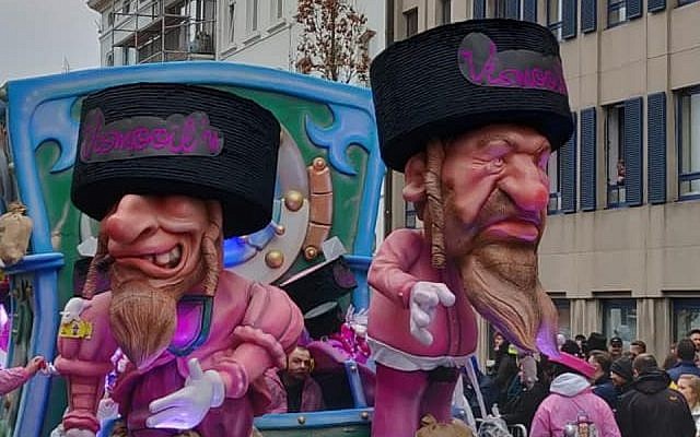A parade float at the Aalst Carnaval in Belgium featuring caricatures of Orthodox Jews atop money bags, March 3, 2019. (Courtesy of FJO, via JTA)