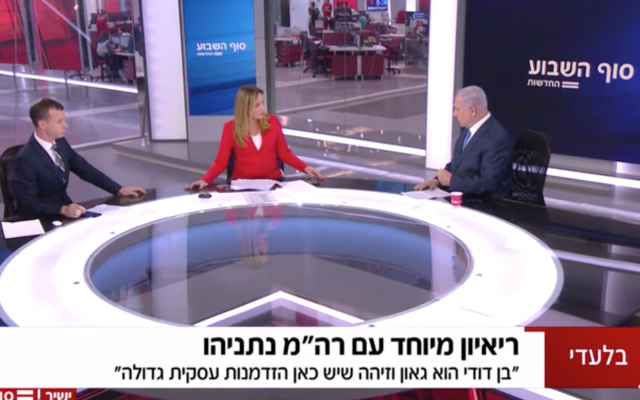 Prime Minister Benjamin Netanyahu (right) is interviewed on Channel 12 by Amit Segal and Keren Marciano (Channel 12 screenshot)