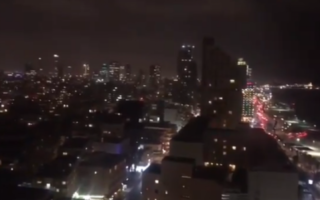 Screen capture from video showing the Tel Aviv skyline on March 14 as rocket warning sirens blare after the launch of two rockets from the Gaza Strip (IDF)