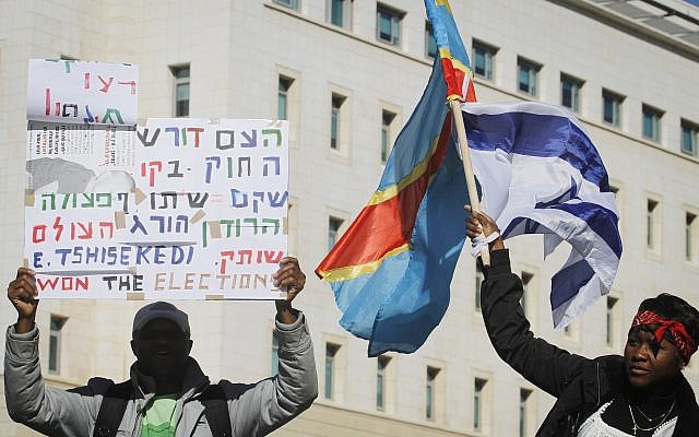 Congolese activists demonstrate outside Prime Minister Netanyahu's office in Jerusalem, calling for the Israeli government to disregard newly elected Congolese president Joseph Kabila and to support leader of opposition Etienne Tshisekedi as new president, on December 18, 2011. (Miriam Alster/FLASH90)