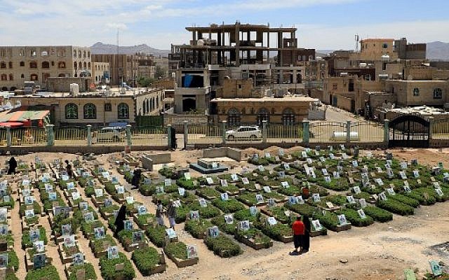 Yemenis visiting a cemetery in the capital Sanaa on April 5, 2019 with graves of victims from the ongoing civil war.  (Mohammed HUWAIS/AFP)