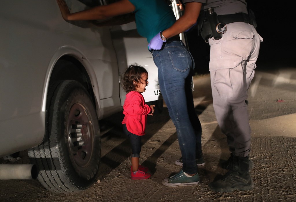 In this file photo taken on June 12, 2018 a two-year-old Honduran asylum seeker cries as her mother is searched and detained near the US-Mexico border in McAllen, Texas. (Photo by JOHN MOORE / GETTY IMAGES NORTH AMERICA / AFP)