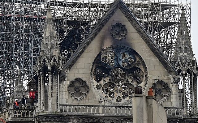 Inspectors are seen on the roof of the landmark Notre-Dame Cathedral in central Paris on April 16, 2019, the day after a fire ripped through its main roof. (Lionel BONAVENTURE / AFP)