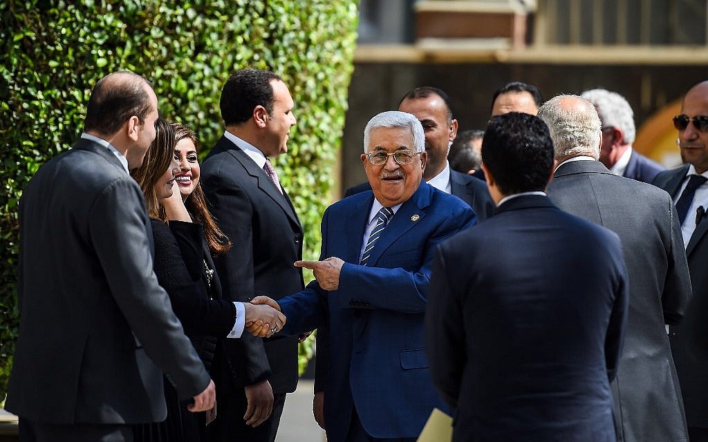 Palestinian Authority President Mahmoud Abbas (C) is greeted upon his arrival at the Arab League headquarters in the Egyptian capital Cairo, to discuss the latest developments in the Palestinian territories on April 21, 2019. (MOHAMED EL-SHAHED / AFP)