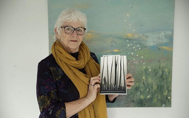 Elly Wright, a Dutch painter who has lived in Britain for 51-years, poses for photographs with a copy of the book "In Limbo", in which her Brexit testimonial story is one of those featured, at her home in Epsom, on the south west edge of London, Wednesday, April 10, 2019. Britain’s seemingly endless debate over leaving the European Union has brought division, strife and fear of foreigners, and the trauma has shattered Wright's sense of belonging. (AP Photo/Matt Dunham)