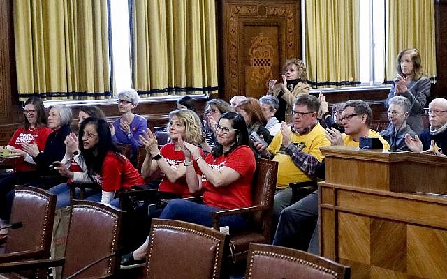 People in attendance applaud after the Pittsburgh City Council voted 6-3 to pass gun-control legislation, Tuesday, April 2, 2019, in Pittsburgh. The bill, introduced in the wake of the synagogue massacre last October, places restrictions on military-style assault weapons like the AR-15 rifle that authorities say was used in the attack that killed 11 and wounded seven. (AP Photo/Keith Srakocic)
