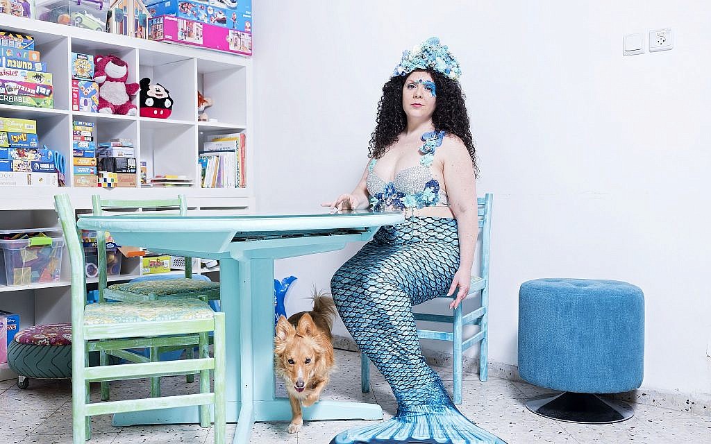 In this Monday, March. 4, 2019 photo, Inbar Ben Yakar, a member of the Israeli Mermaid Community, poses for a portrait as she wears a mermaid tail at her home in Kiryat Yam, Israel. (AP Photo/Oded Balilty)